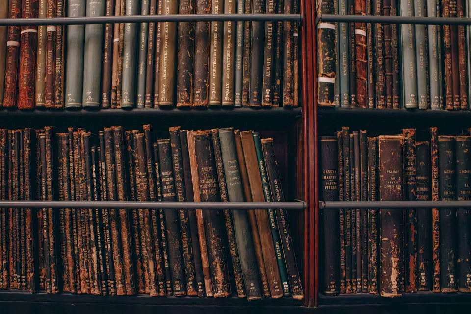 Rows of well-worn books on wooden library shelves